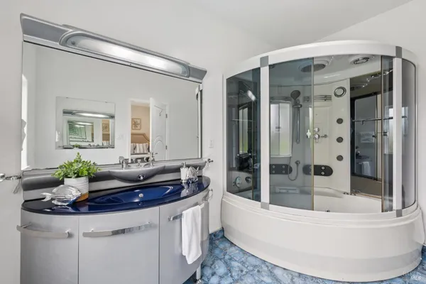 a bath room with a sink and a mirror