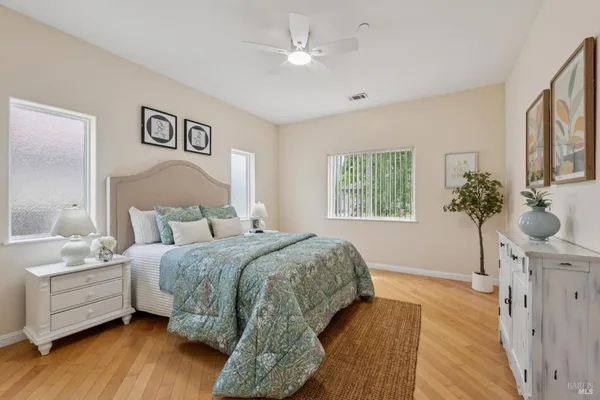 a spacious bedroom with a bed and a window