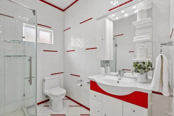 a bathroom with a sink toilet and shower