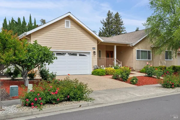 a view of a house with a yard and garden