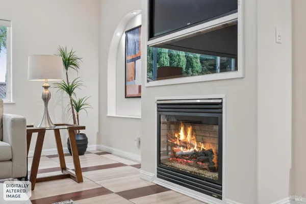 a living room that has a fireplace and a potted plant