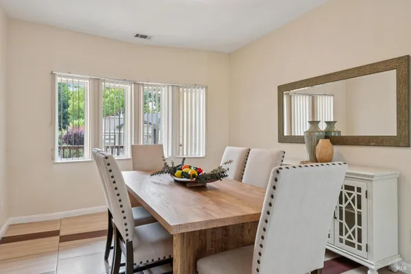 a view of a dining room with furniture and window