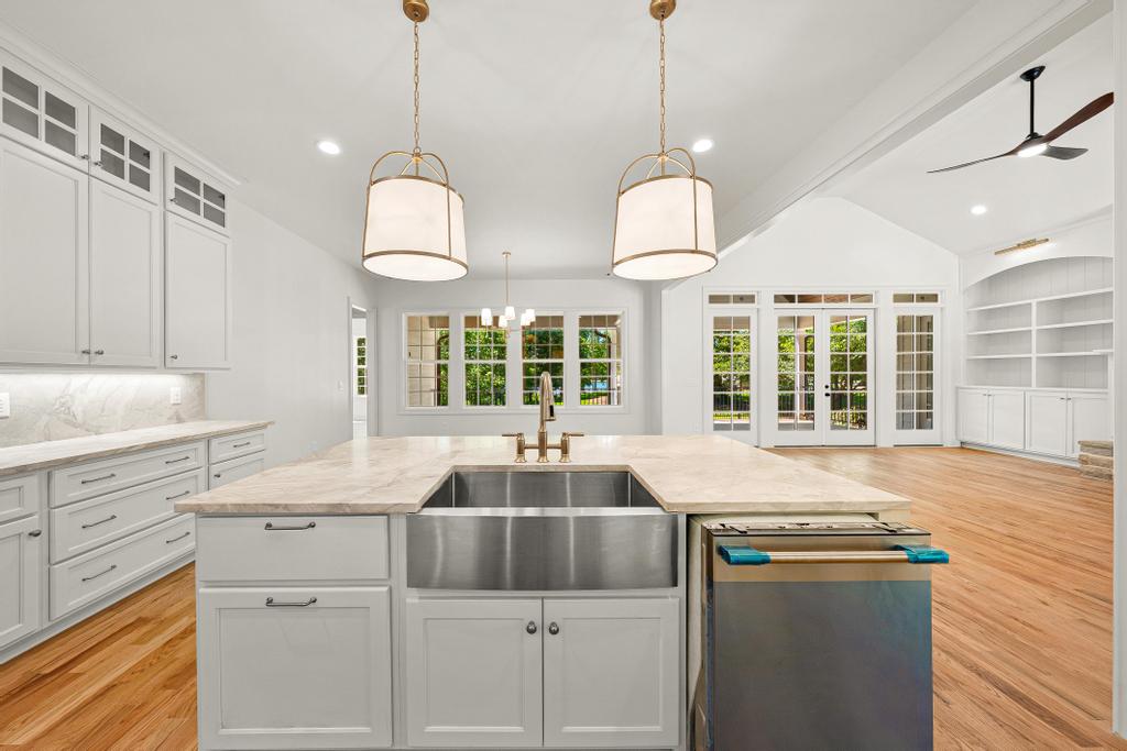707 Vickery Street Extension Hartwell, GA 30643 - Photo 12 of 50 A well-lit kitchen with a large island and ample cabinet space seamlessly flows into a spacious living area.