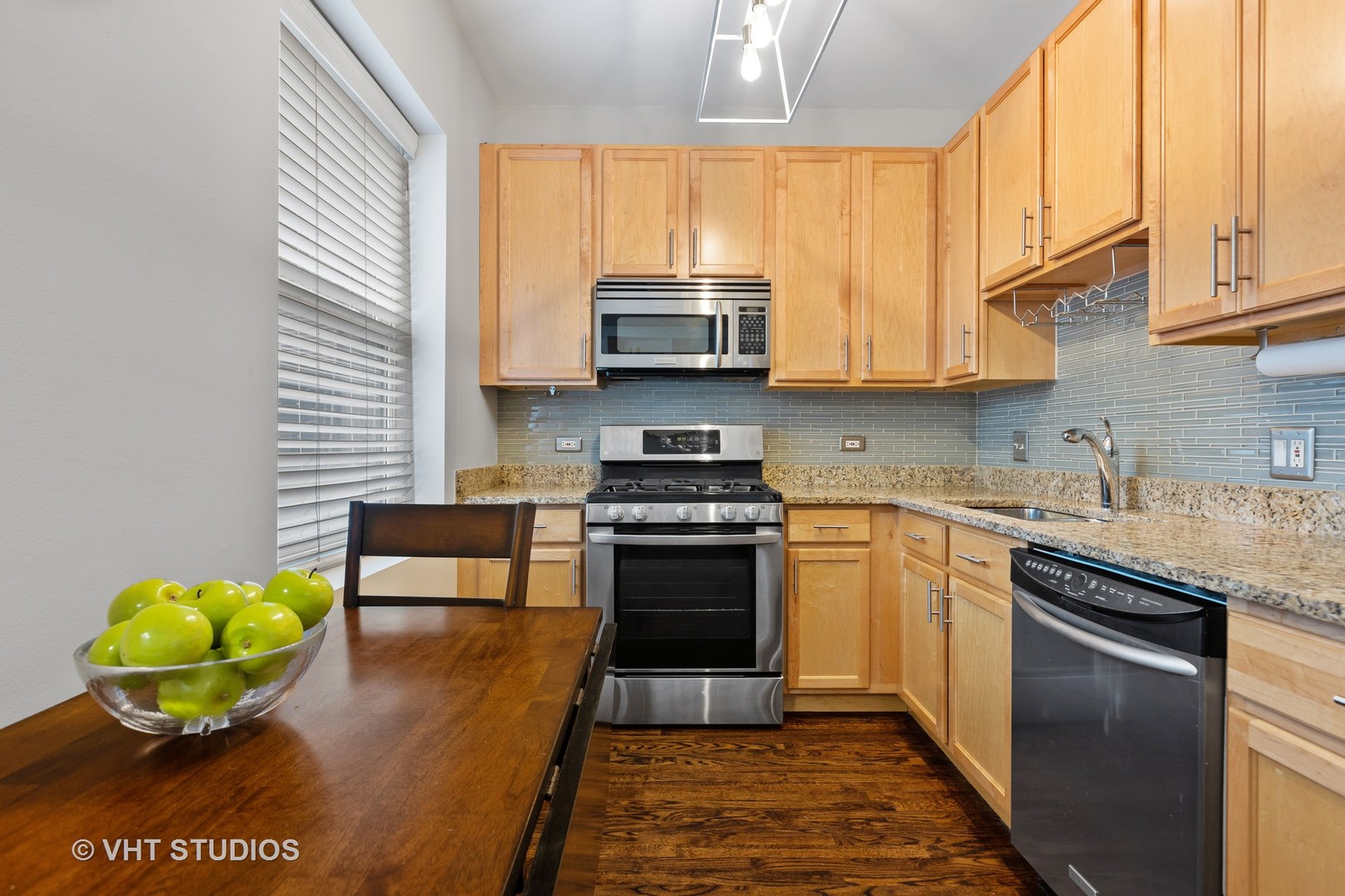1520 West Addison Street, Unit 1 Chicago, IL 60613 - Photo 4 of 12 a kitchen with a stove a sink and a microwave