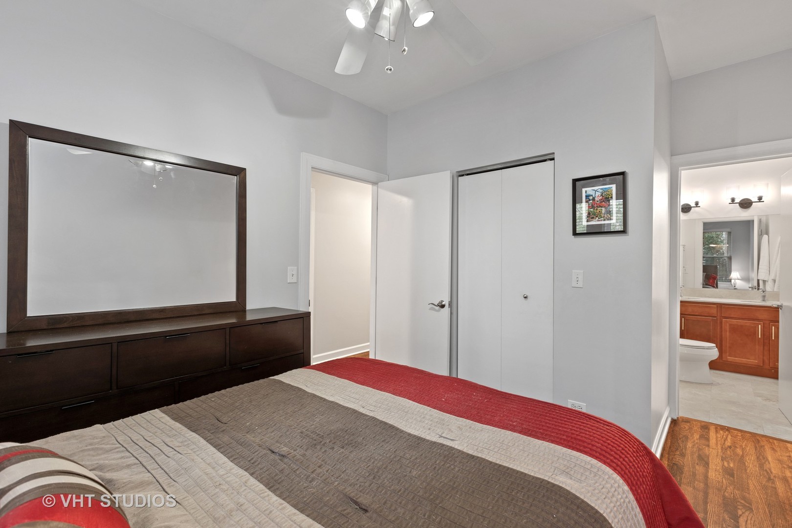 1520 West Addison Street, Unit 1 Chicago, IL 60613 - Photo 6 of 12 a bedroom with a bed and wooden floor