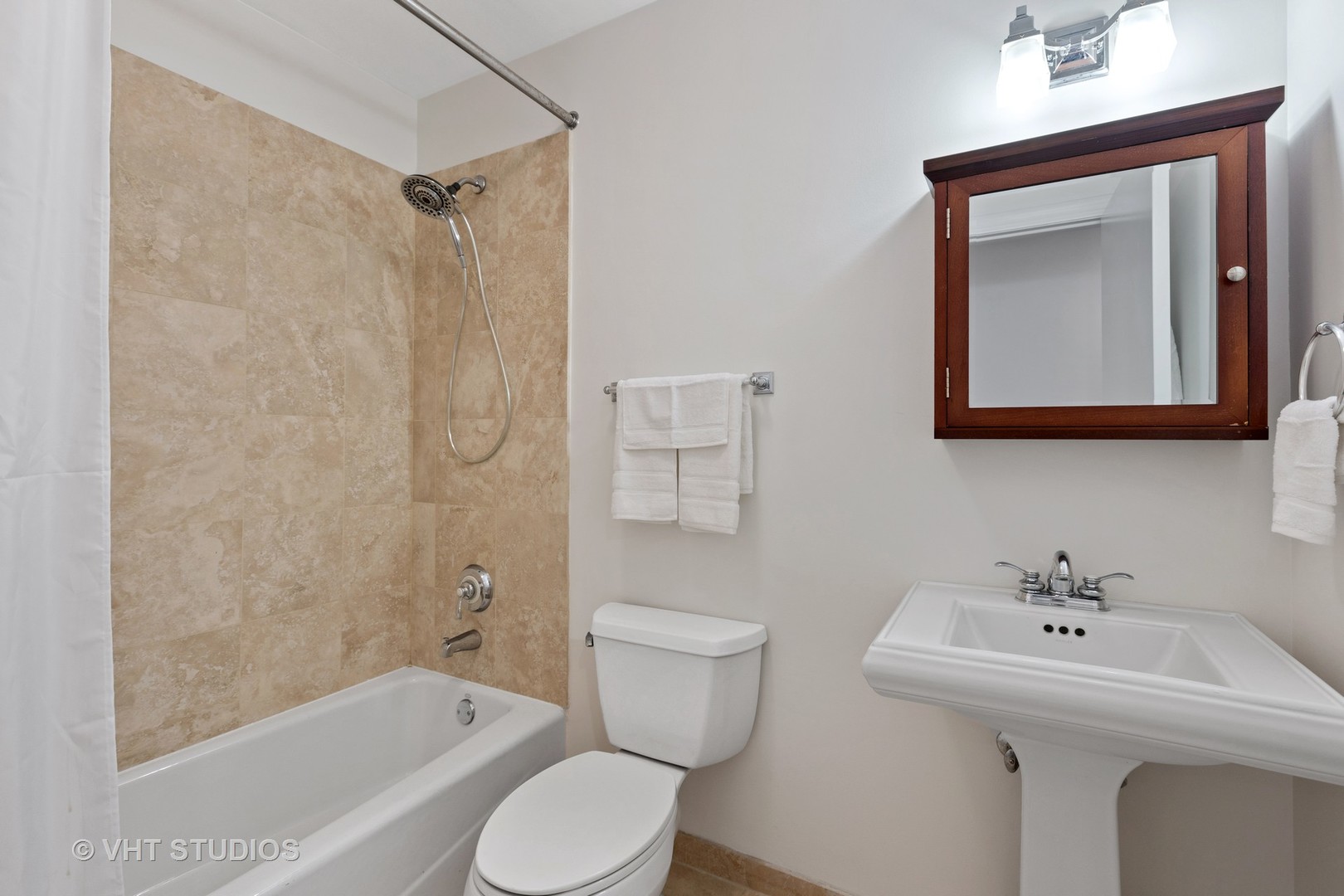 1520 West Addison Street, Unit 1 Chicago, IL 60613 - Photo 9 of 12 a bathroom with a toilet sink and mirror