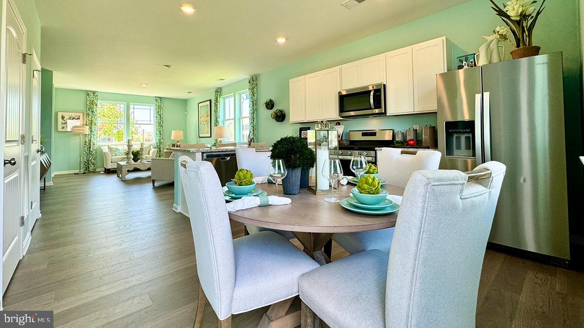 1509 Avon Way Salisbury, MD 21801 - Photo 14 of 27 a view of a dining room with furniture a rug and wooden floor
