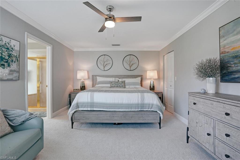 6535 Valen Way, Unit E202 Naples, FL 34108 - Photo 17 of 33 a bedroom with a bed and window