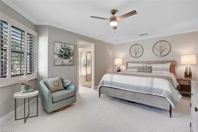 a bedroom with a bed couch and window