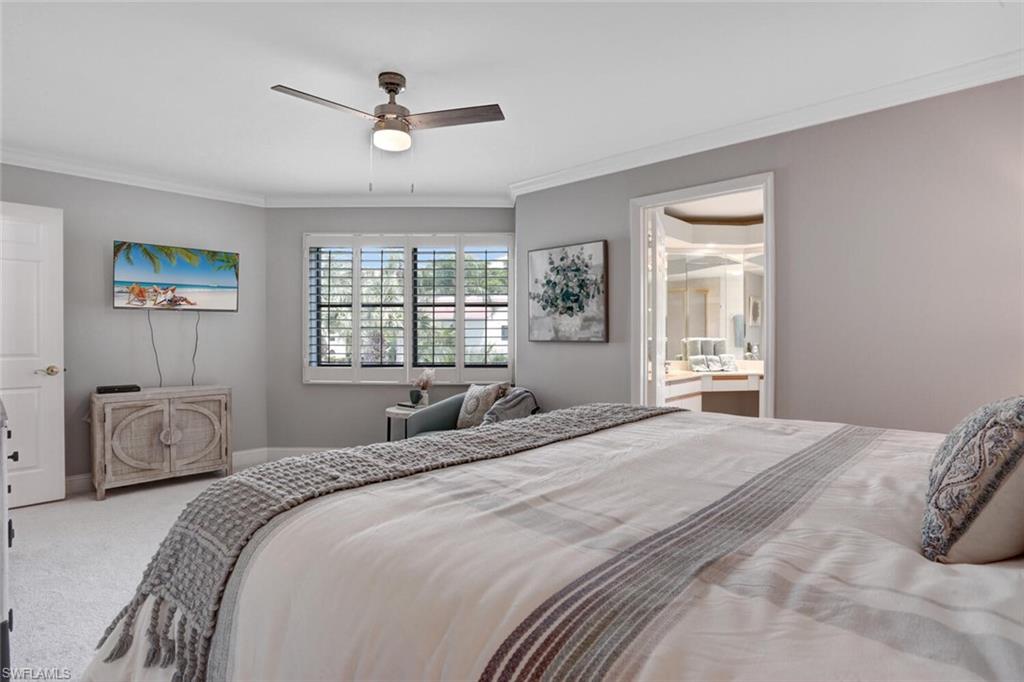 6535 Valen Way, Unit E202 Naples, FL 34108 - Photo 19 of 33 a bedroom with a large bed and a window