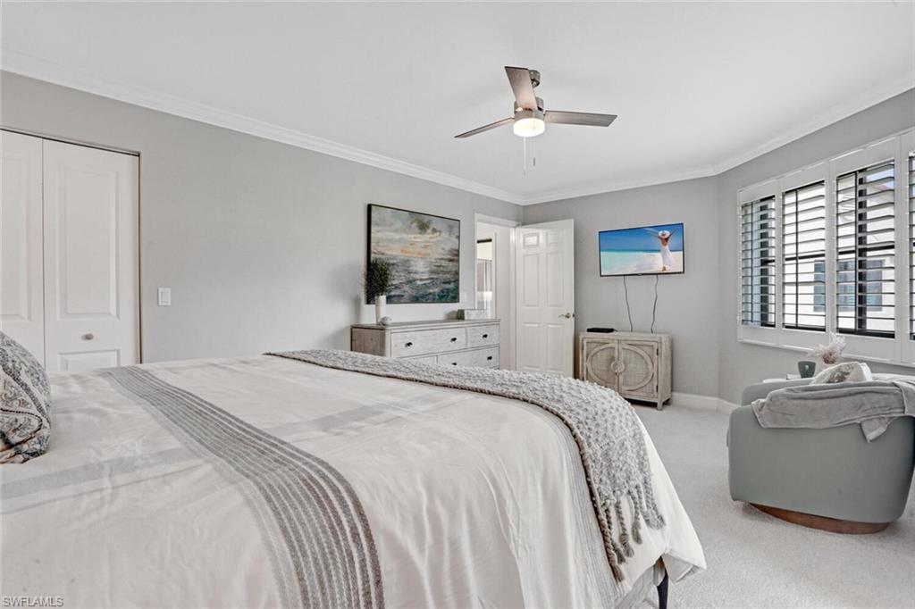 6535 Valen Way, Unit E202 Naples, FL 34108 - Photo 20 of 33 a bedroom with a bed and ceiling fan