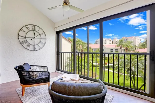 a balcony with table and chairs