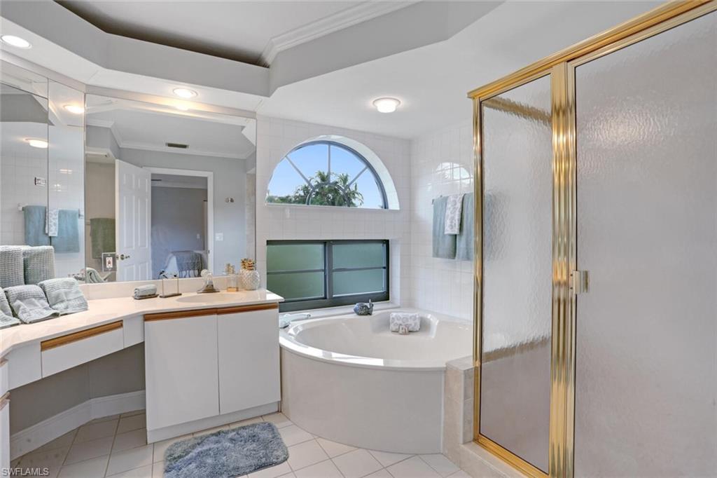 6535 Valen Way, Unit E202 Naples, FL 34108 - Photo 22 of 33 a bathroom with a double vanity sink mirror and double