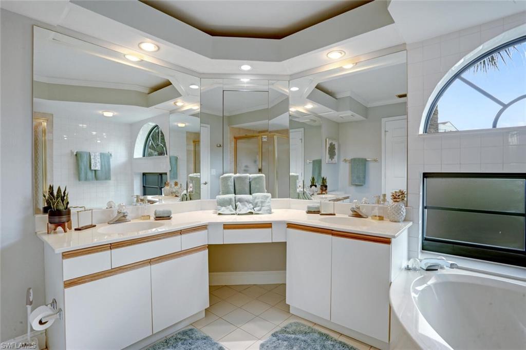 6535 Valen Way, Unit E202 Naples, FL 34108 - Photo 23 of 33 a kitchen with a sink and cabinets