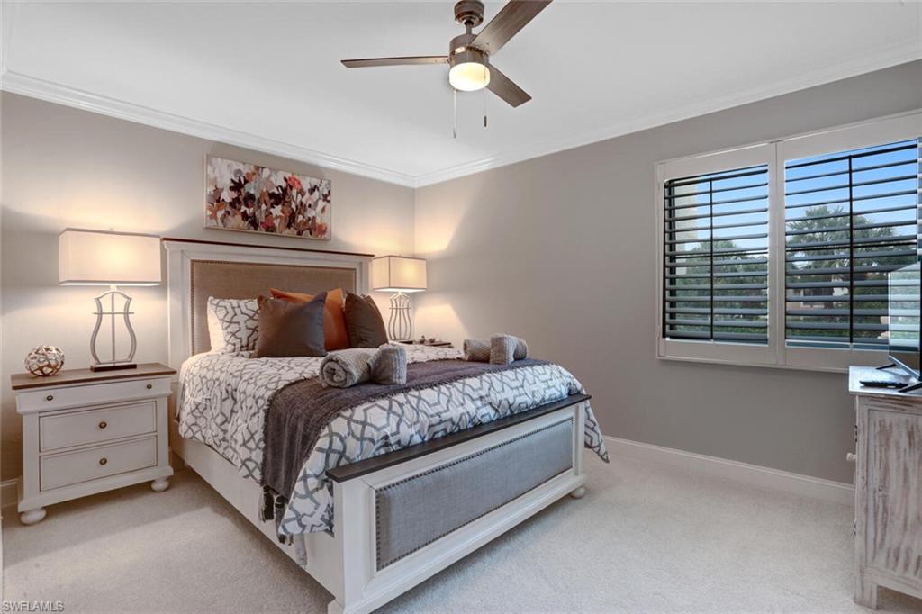 6535 Valen Way, Unit E202 Naples, FL 34108 - Photo 24 of 33 a bedroom with a bed and a window