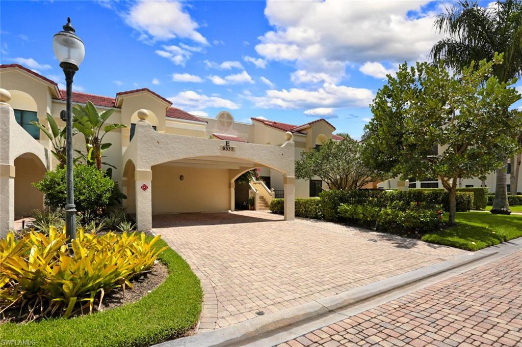6535 Valen Way, Unit E202 Naples, FL 34108 - Photo 32 of 33 a front view of a house with a yard