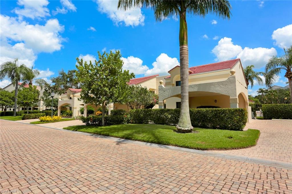 6535 Valen Way, Unit E202 Naples, FL 34108 - Photo 33 of 33 a front view of a house with garden