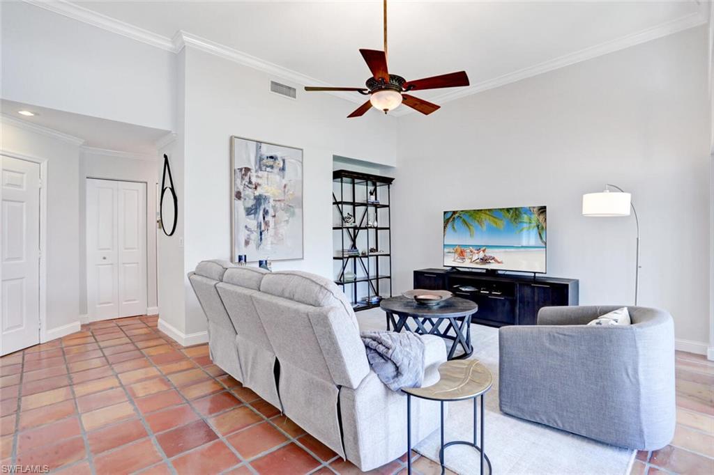 6535 Valen Way, Unit E202 Naples, FL 34108 - Photo 7 of 33 a living room with furniture and a wooden floor