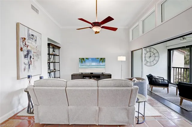 a living room with furniture a clock and a window