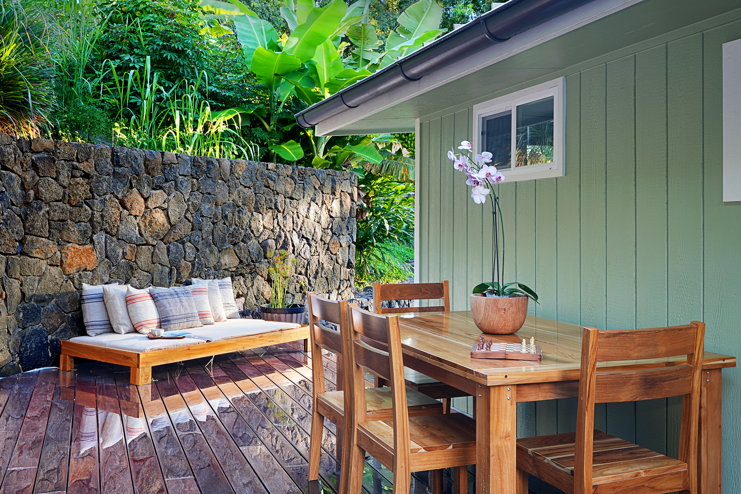 3720 A Moloaa Road Kilauea, HI 96754 - Photo 11 of 20 a wooden bench sitting in front of a building