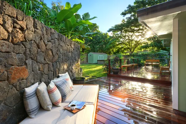 a view of patio with furniture and garden