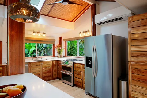 a kitchen with stainless steel appliances granite countertop a refrigerator a sink and a stove