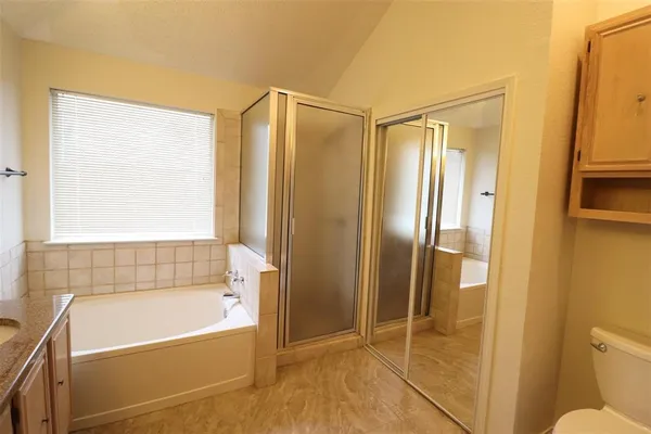 a bathroom with a tub and a shower