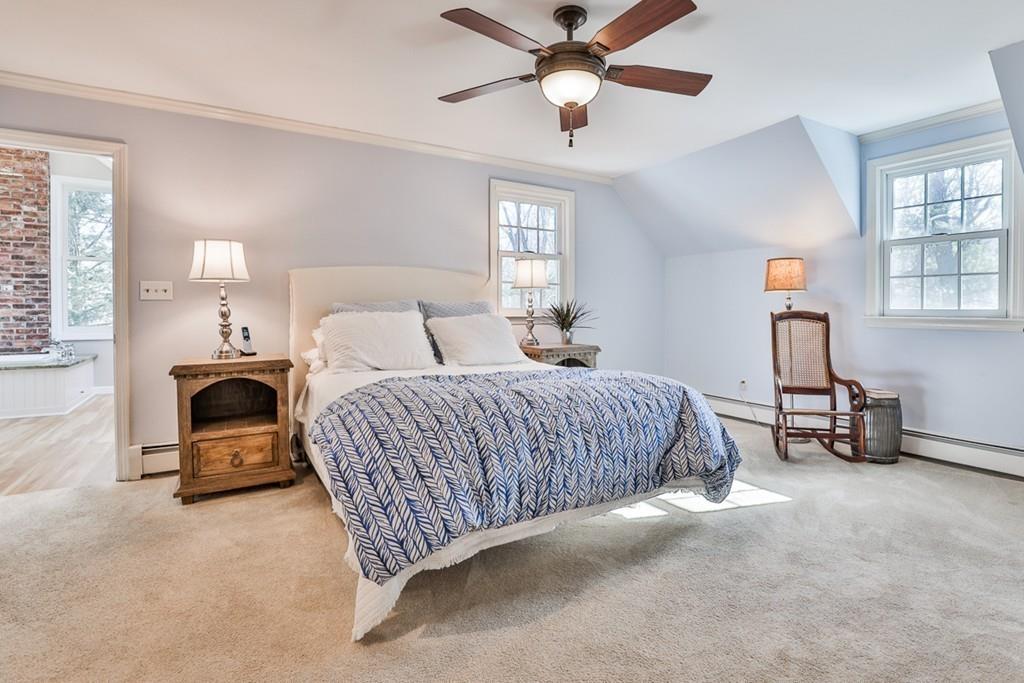 13 Sheffield Road Boxford, MA 01921 - Photo 20 of 41 a bedroom with a bed and a chandelier