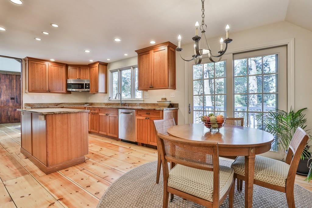 13 Sheffield Road Boxford, MA 01921 - Photo 3 of 41 a kitchen with stainless steel appliances granite countertop a stove a sink a microwave a dining table and chairs
