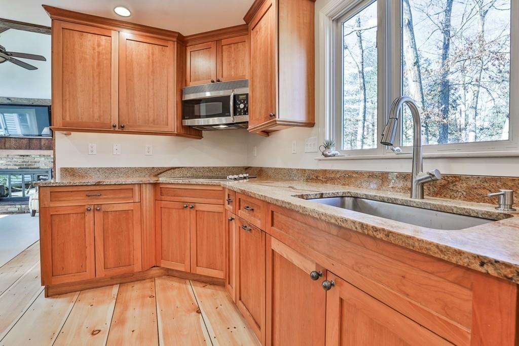 13 Sheffield Road Boxford, MA 01921 - Photo 5 of 41 a kitchen with stainless steel appliances granite countertop a stove a sink and a microwave