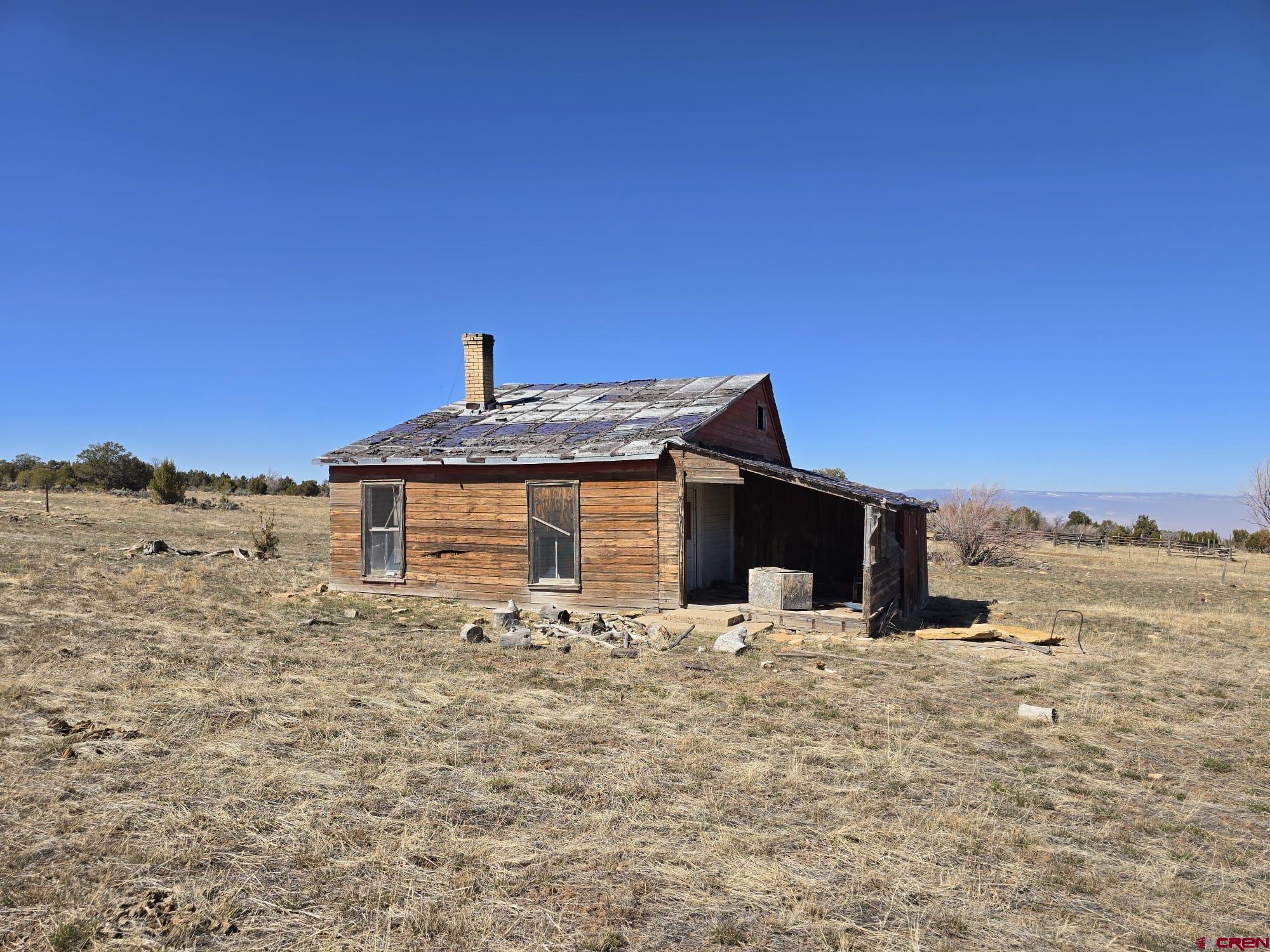 13670 Transfer Road Olathe, CO 81425 - Photo 20 of 23 a front view of a house with a yard