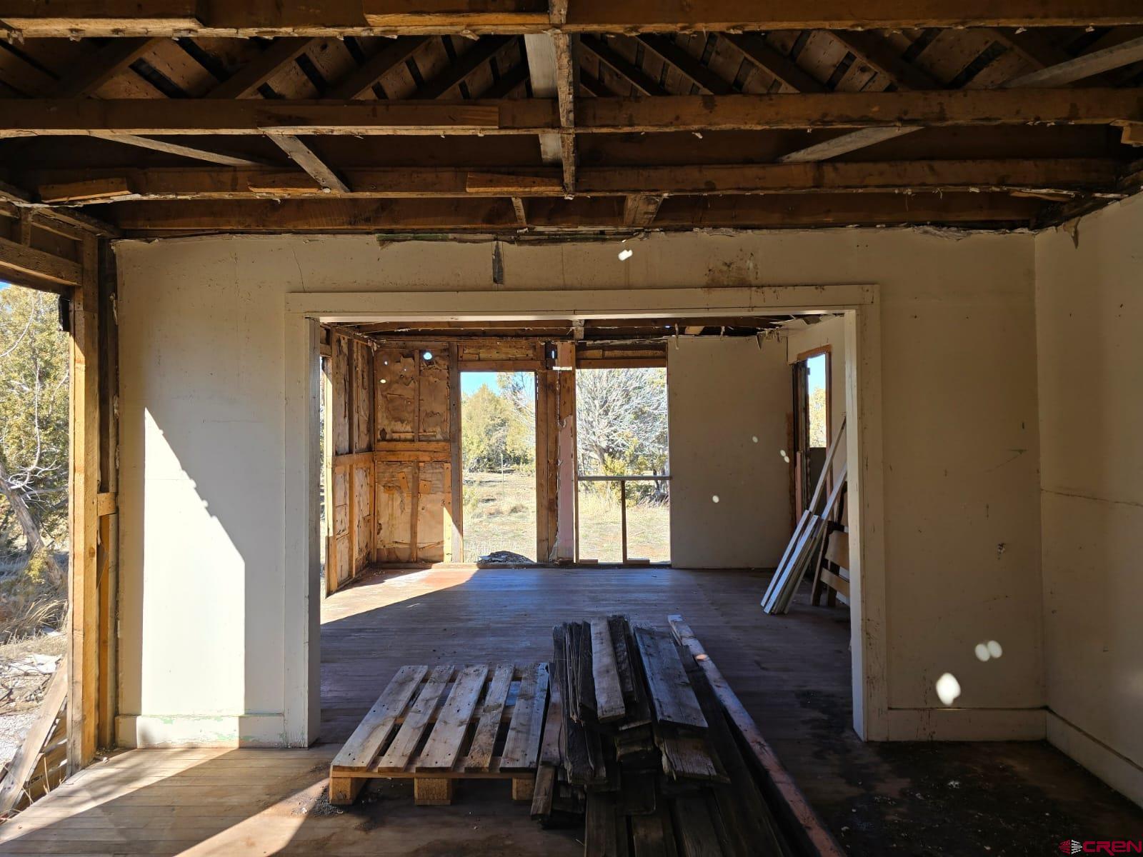 13670 Transfer Road Olathe, CO 81425 - Photo 10 of 23 a view of a room with wooden floor and windows