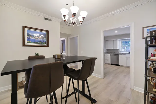 a view of a dining room with furniture and chandelier