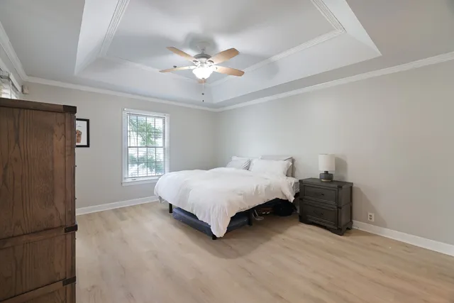 a spacious bedroom with a bed and window