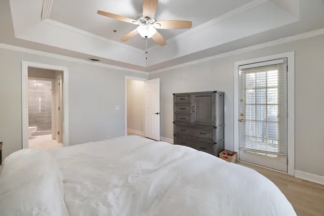 a bedroom with a large bed and a chandelier