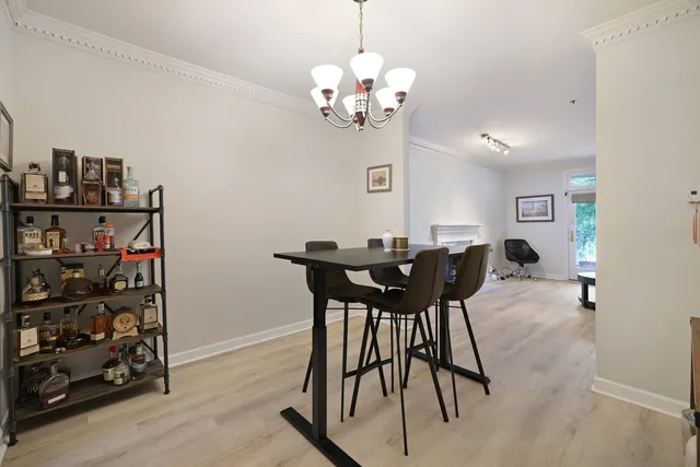 a view of a dining room with furniture and chandelier