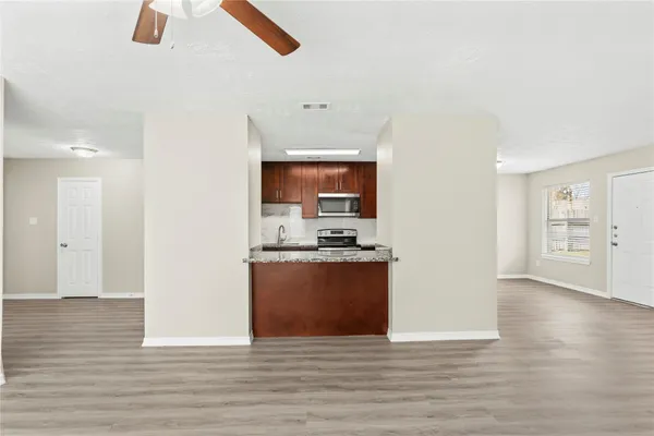 a view of a kitchen with wooden floor
