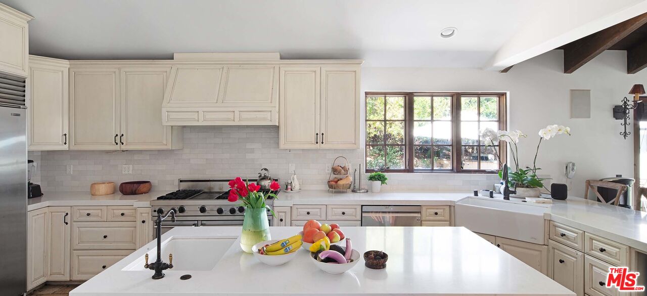2251 Cold Canyon Road Calabasas, CA 91302 - Photo 12 of 47 a kitchen with a sink stove and cabinets