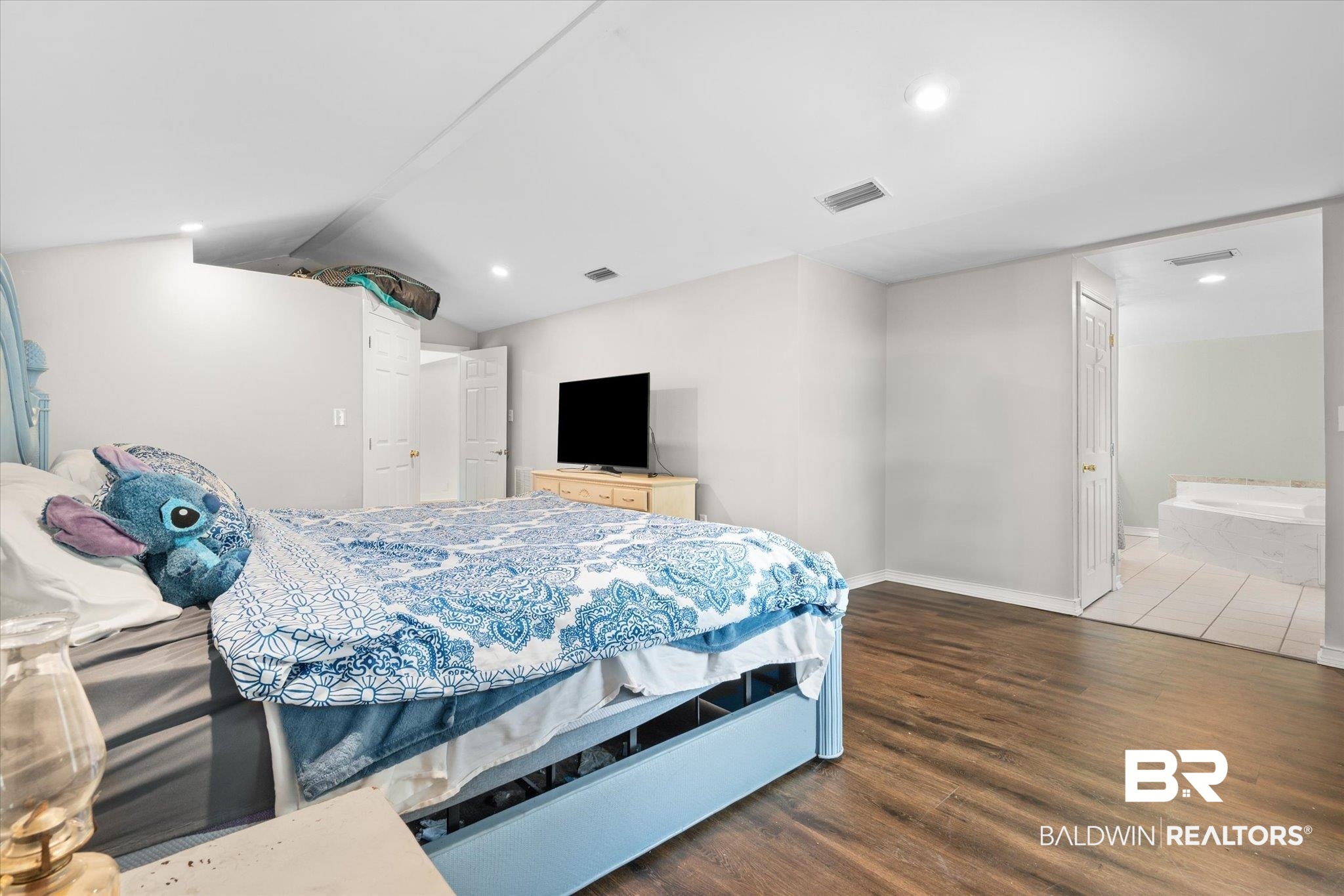529 Cleveland Road Saraland, AL 36571 - Photo 13 of 31 Bedroom featuring vaulted ceiling, visible vents, recessed lighting, wood finished floors, and baseboards
