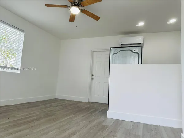 wooden floor in an empty room with a window