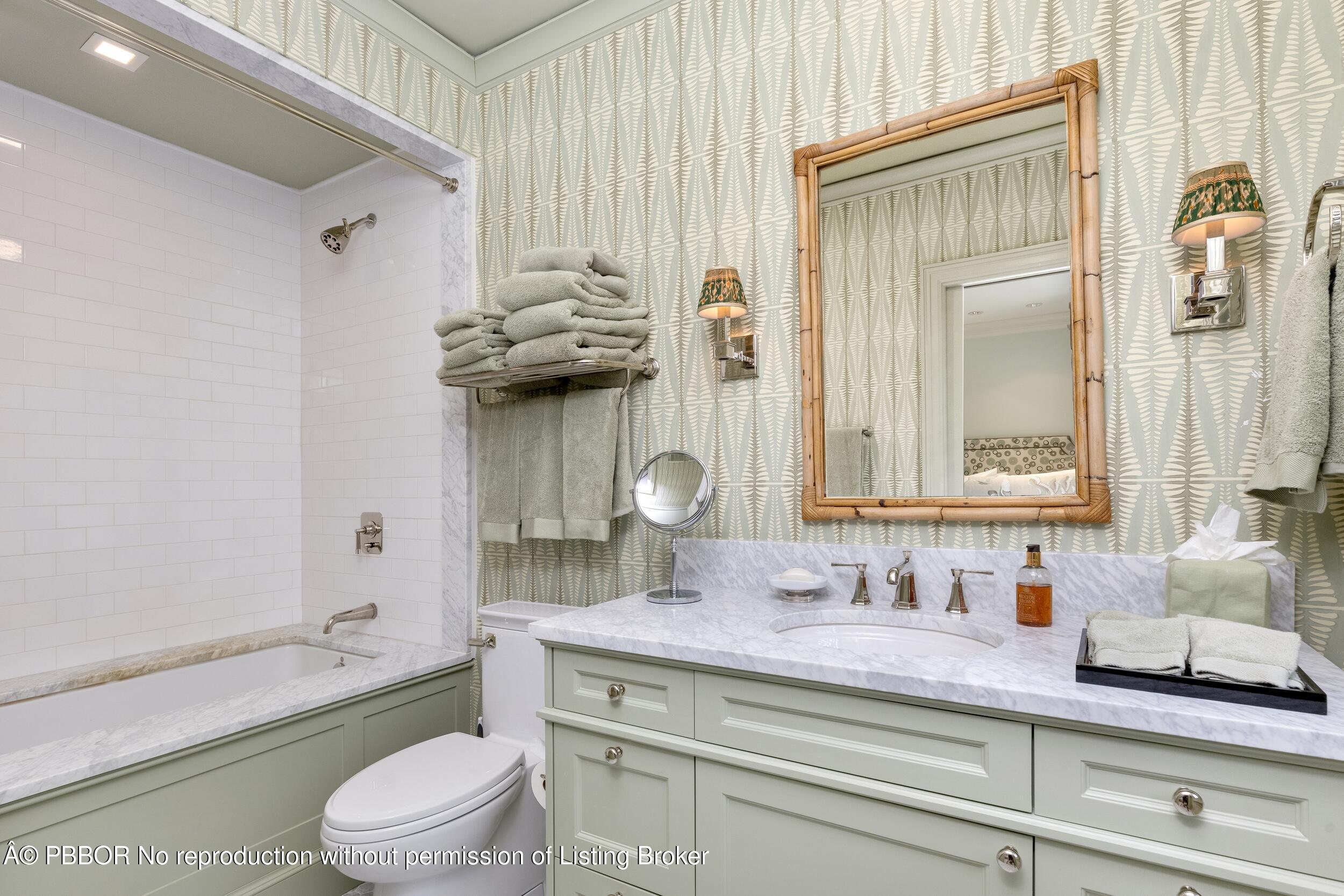 258 List Road Palm Beach, FL 33480 - Photo 29 of 45 a bathroom with a granite countertop sink a toilet and a mirror