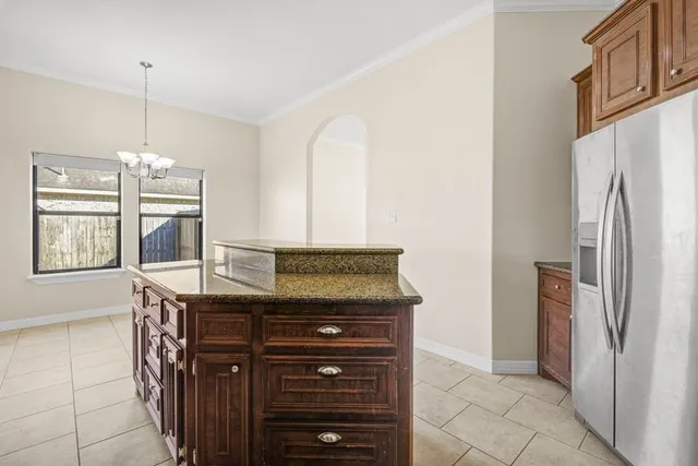 a kitchen with granite countertop a refrigerator and a stove