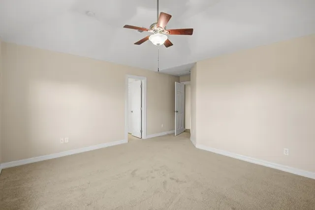 a spacious bathroom with a tub sink and a mirror