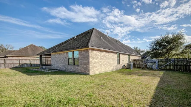 a view of a backyard with wooden fence