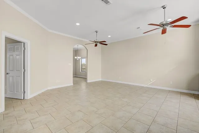 a view of a room with a ceiling fan and shower