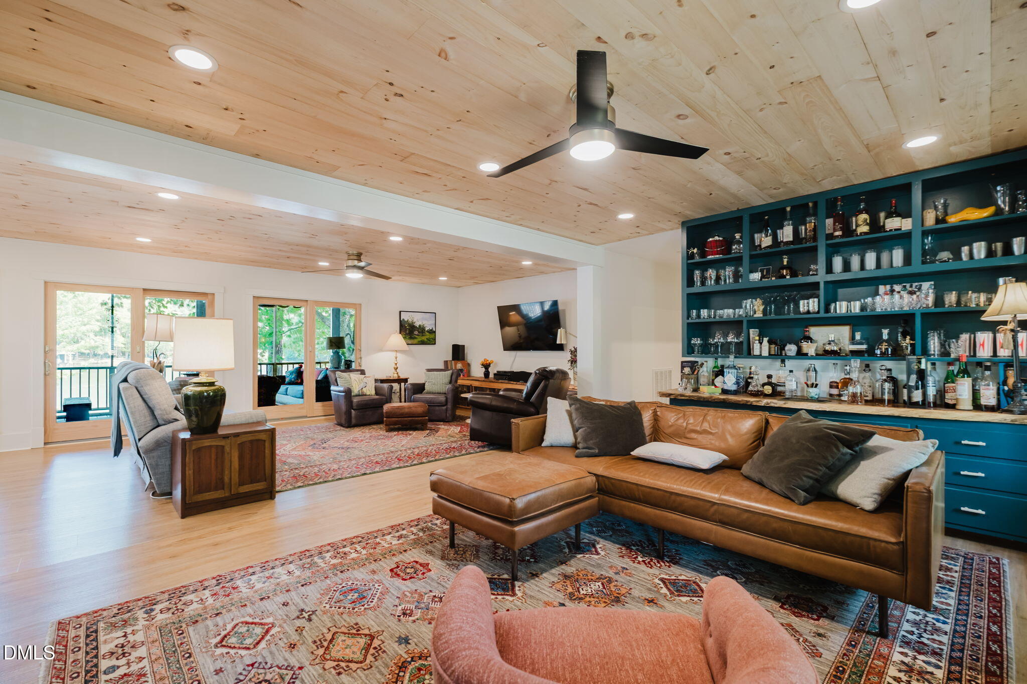 370 Robinson Ferry Road Macon, NC 27551 - Photo 28 of 85 a living room with furniture a rug and a book shelf