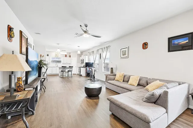 a living room with furniture and a wooden floor