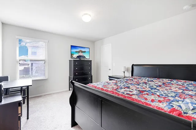 a living room with furniture and a ceiling fan