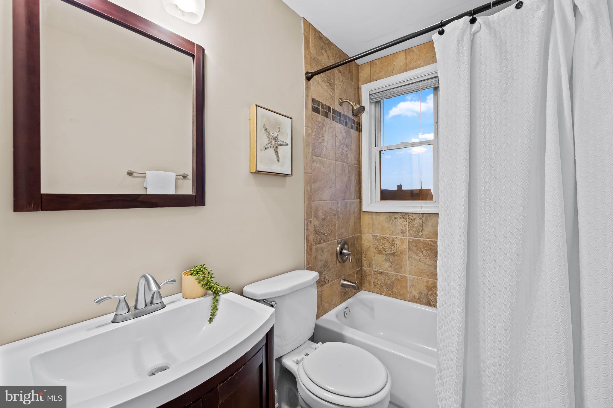 1817 Dunmere Road Baltimore, MD 21222 - Photo 16 of 27 a bathroom with a sink vanity mirror and toilet