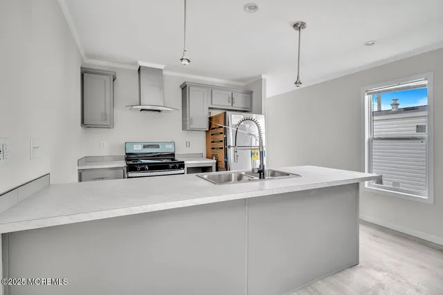 a kitchen with stainless steel appliances granite countertop a sink a stove and a refrigerator